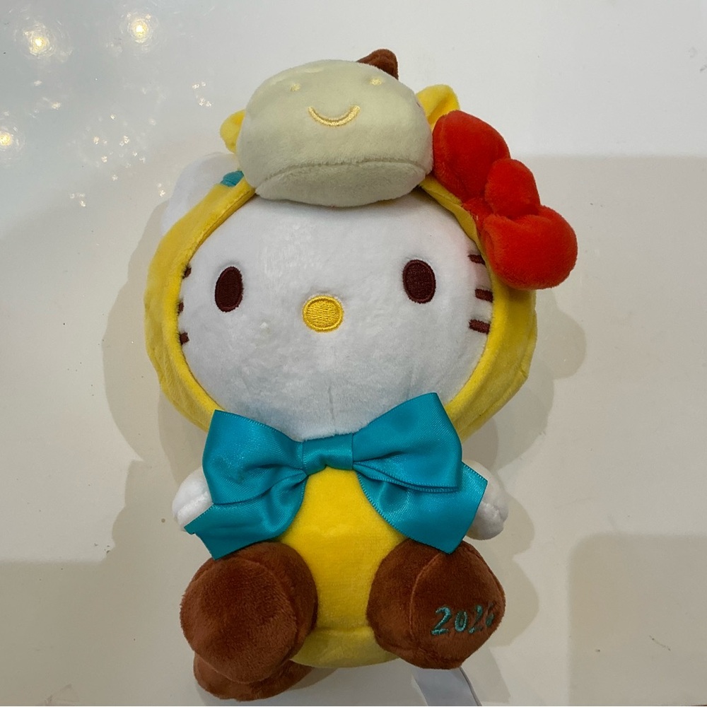 Hello Kitty in Yellow Dino Costume with Blue Bow